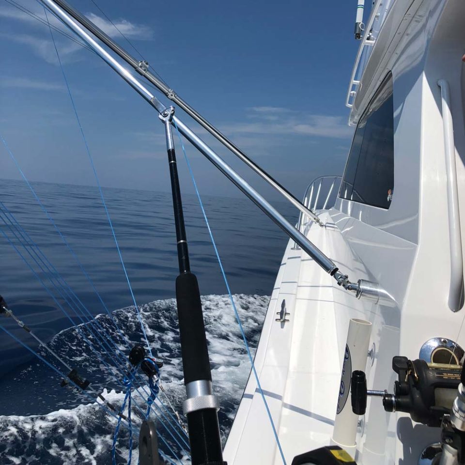Yacht on water with a fishing rod