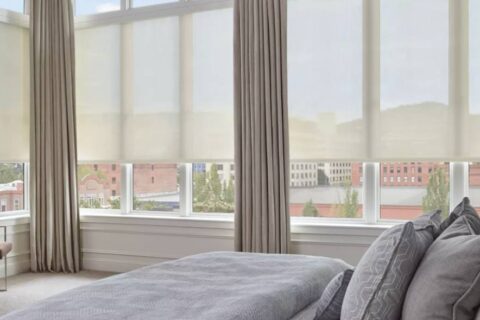 Hunter Douglas solar shades covering multiple windows in a contemporary bedroom near Richmond, VA