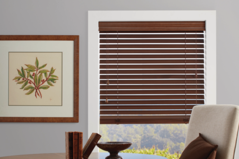 Hunter Douglas Everwood® Faux Wood Blinds covering a window in a rustic living room.