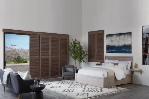 Hunter Douglas shutters in a coastal-themed bedroom.
