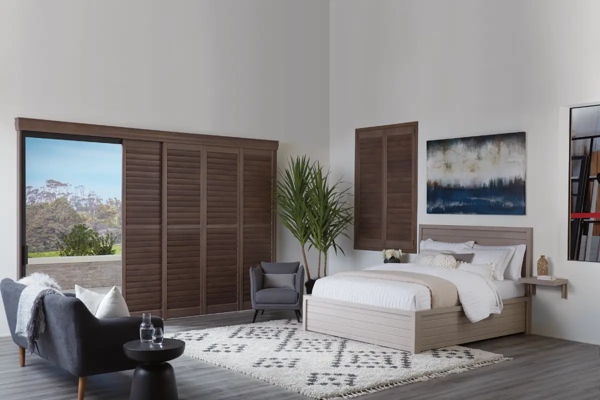 Hunter Douglas shutters in a coastal-themed bedroom.